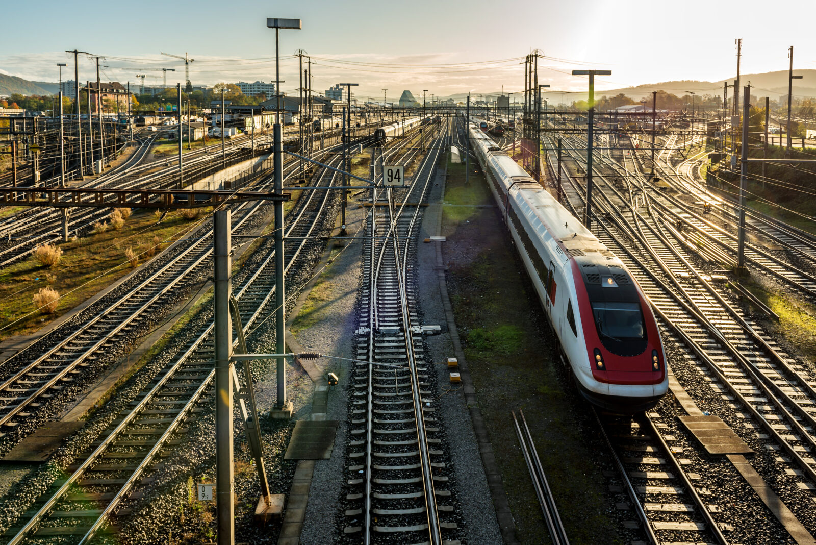 Overview on railway tracks and swiss SBB train approaching