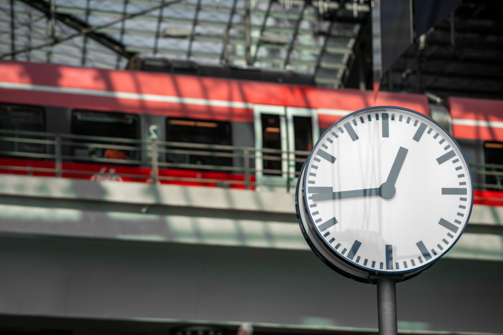 Clock on the background of a train at the railway station