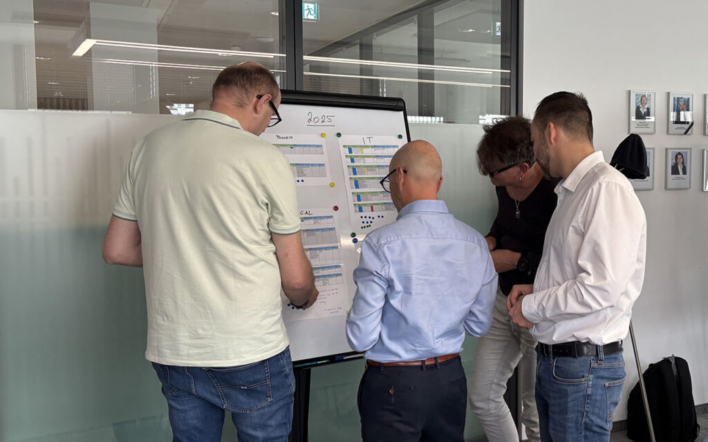 group of 4 workshop participants standing around a flipchart